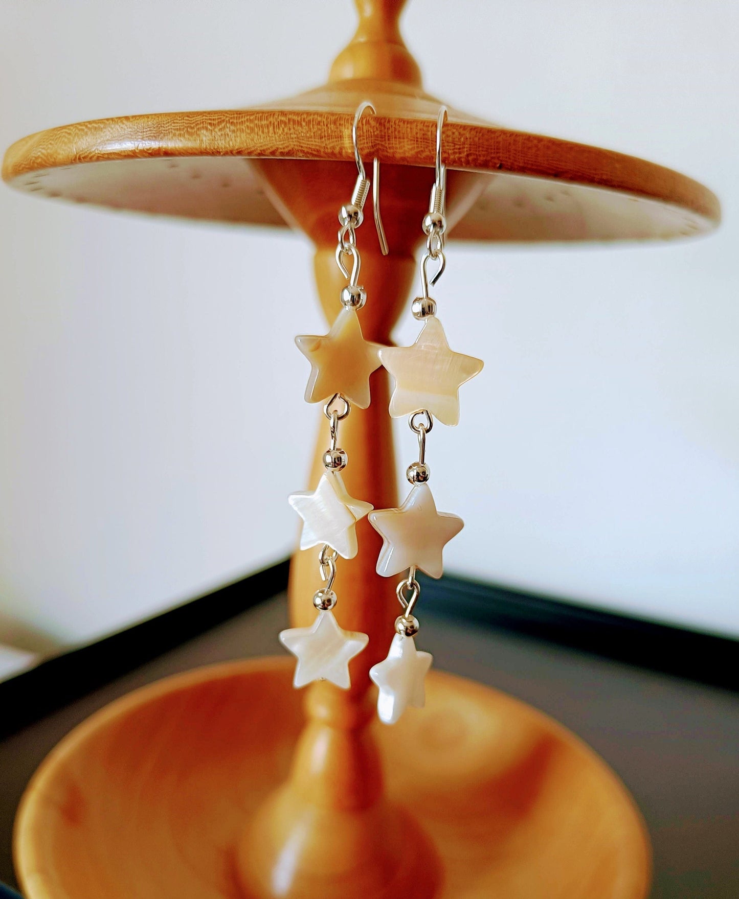 Maurea Mother of Pearl Star Silver Earrings with three delicate star-shaped beads hanging from sterling silver hooks.
