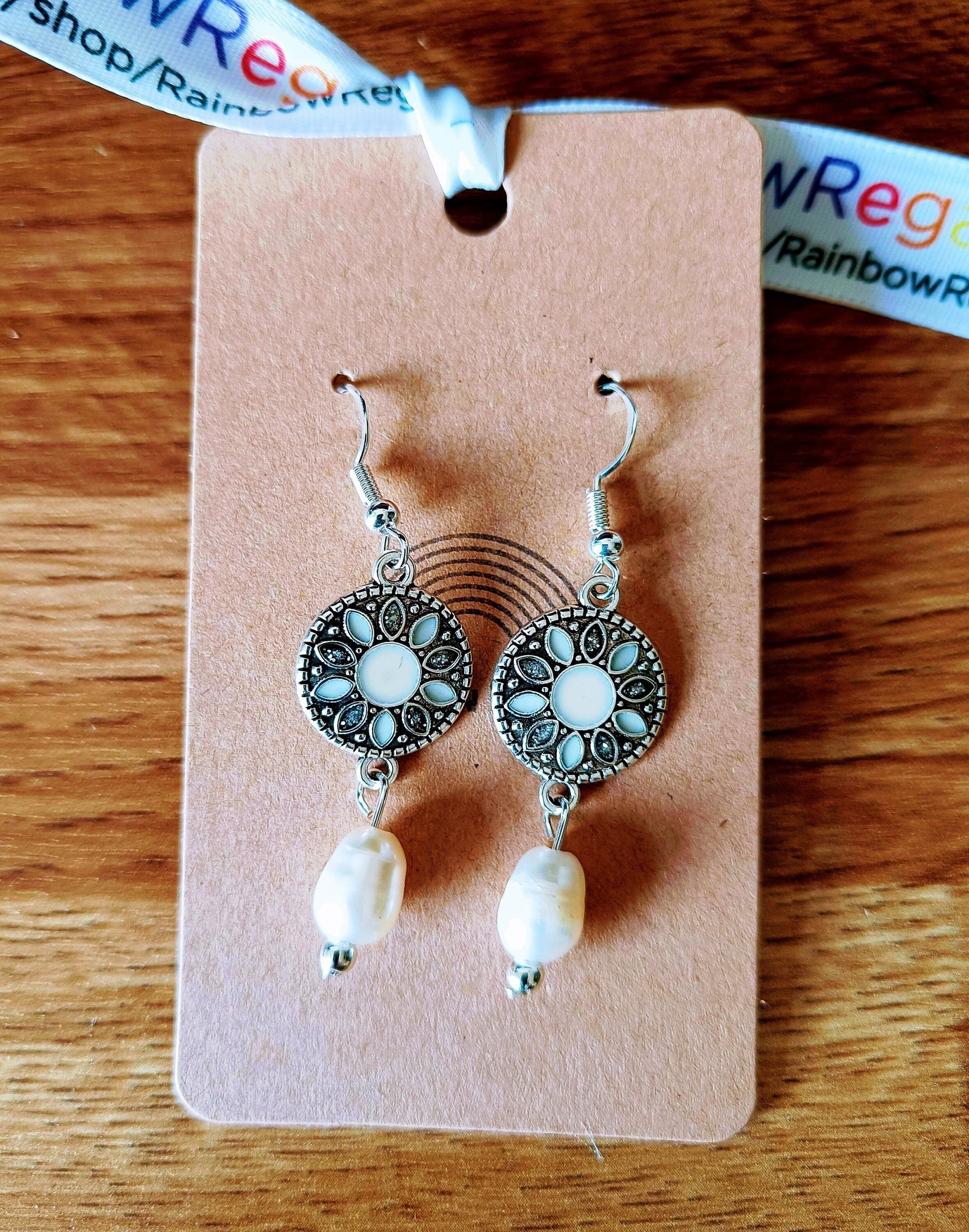 Diana Pearl Drop Earrings with freshwater pearls, enamelled discs, and silver-plated beads on a display card.