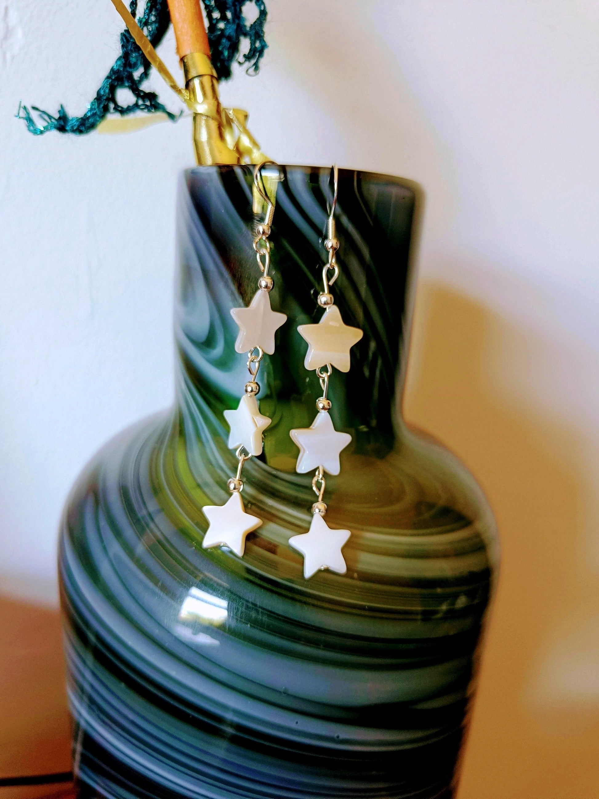 Maurea Mother of Pearl star silver earrings with dangling star-shaped beads.
