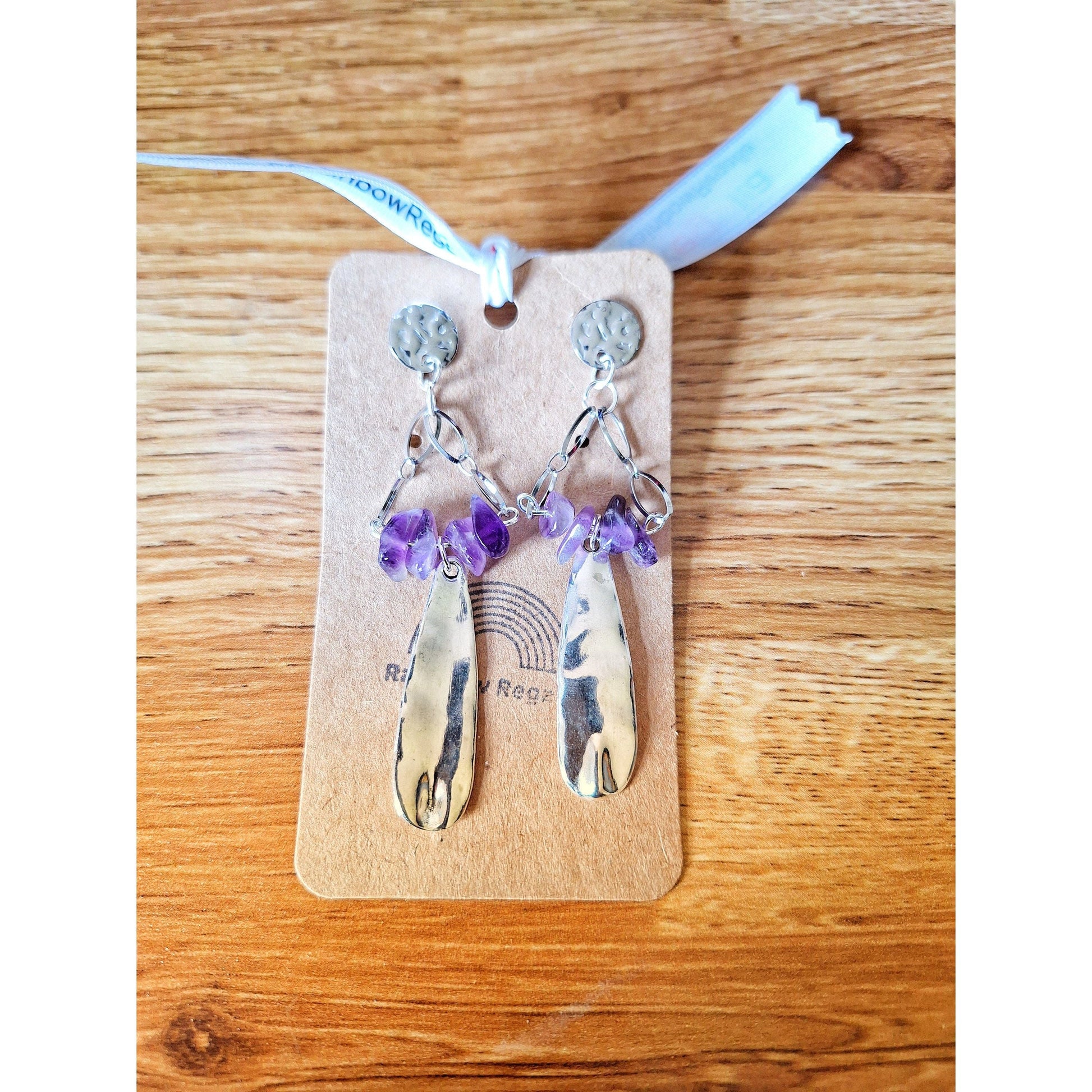 Aurora Chandelier Earrings with amethyst chips and hammered stainless steel on display.