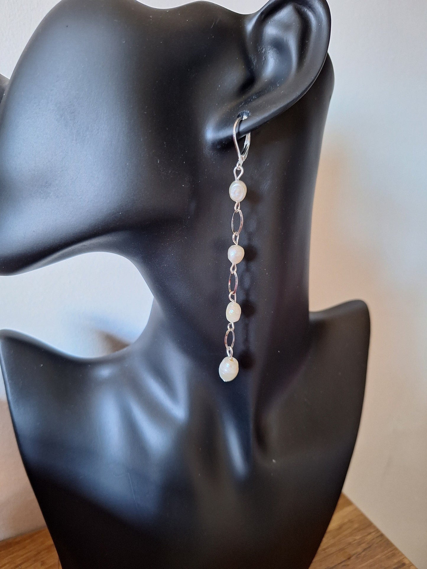 Vivienne Pearl Drop Earrings on display mannequin, showcasing long chain design with freshwater pearls in silver.