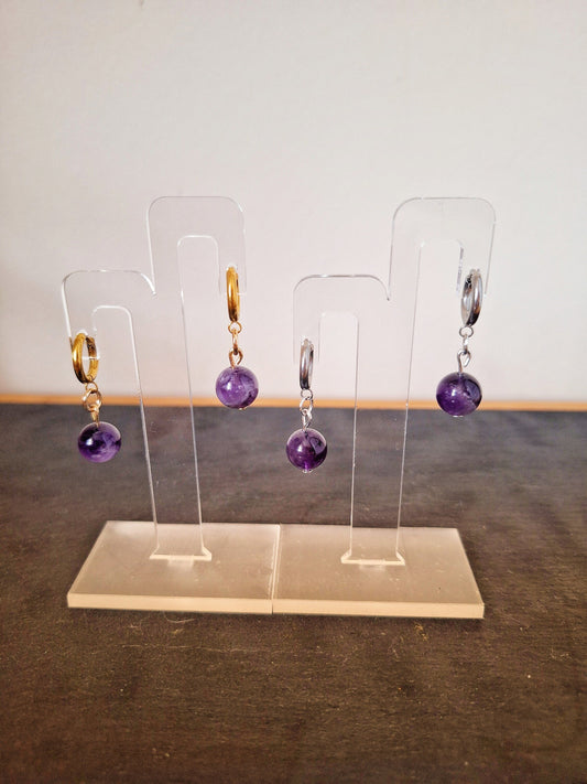 Lydia Amethyst Huggies with genuine amethyst beads on stainless steel and gold-plated hoops, showcasing elegant and versatile design.