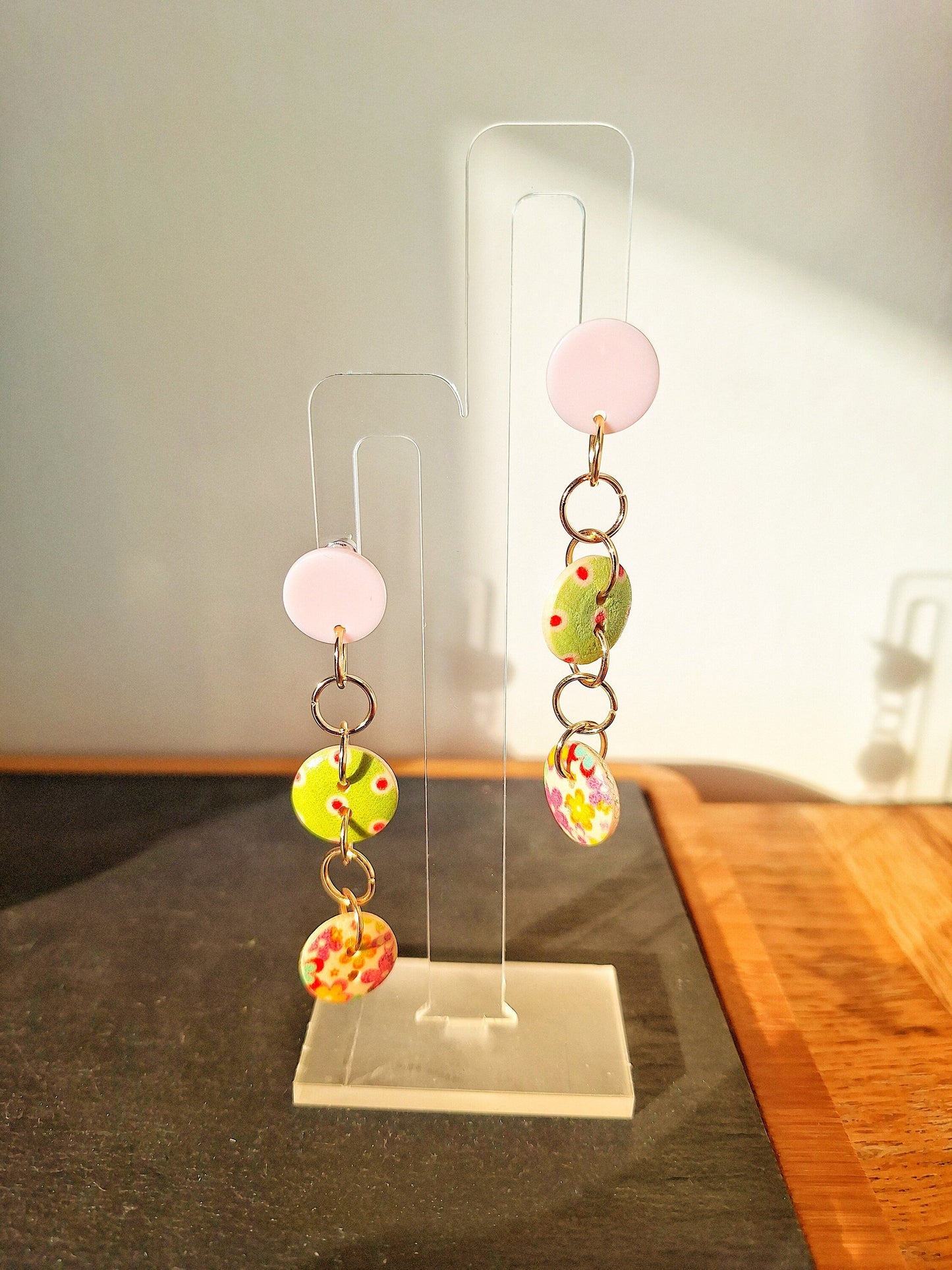 Eco-friendly Bella Button Earrings in blue and pink with wooden buttons and acrylic discs.