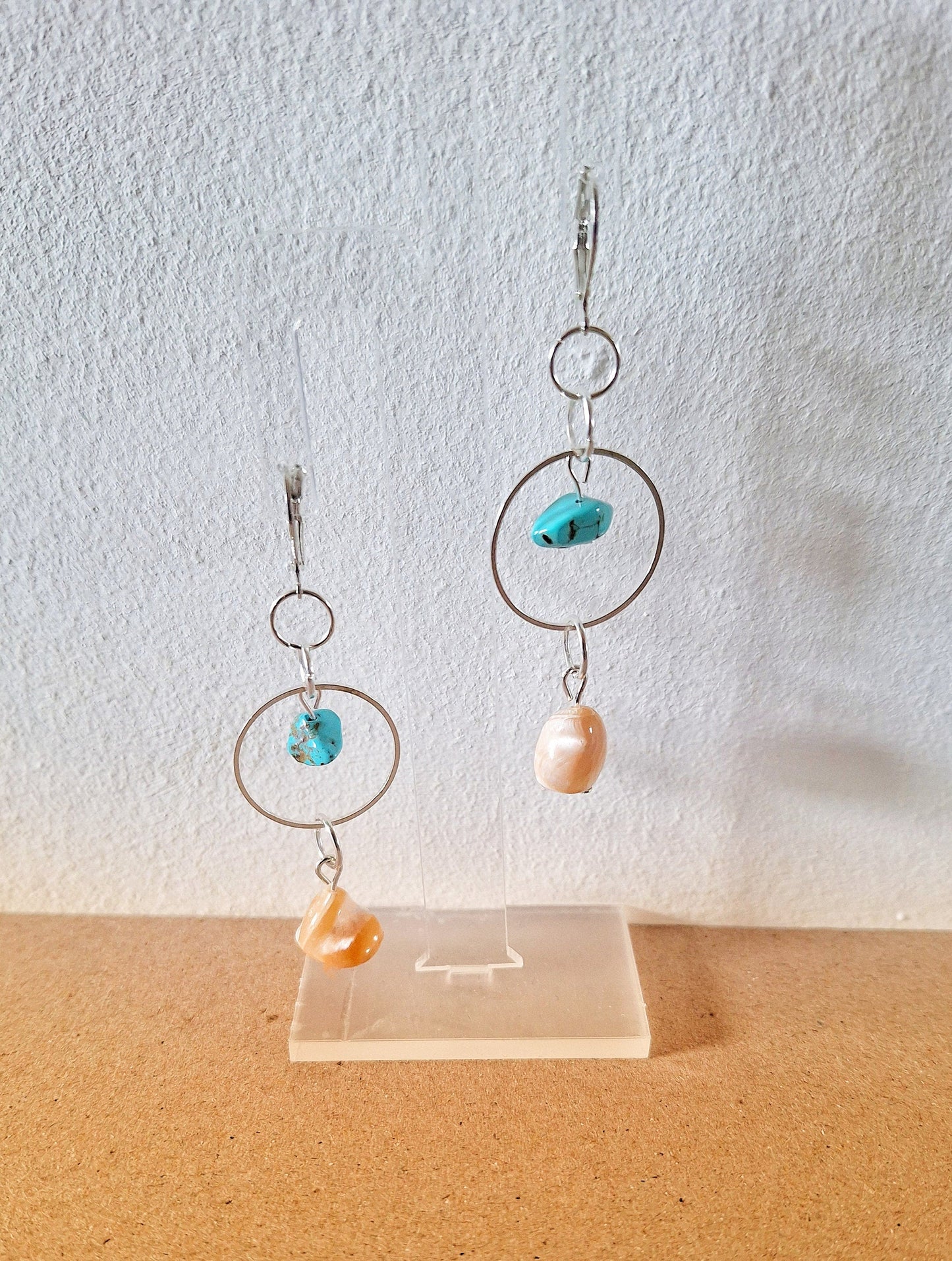 Isla Turquoise and Mother of Pearl Earrings featuring handcrafted turquoise and pearl accents on display.