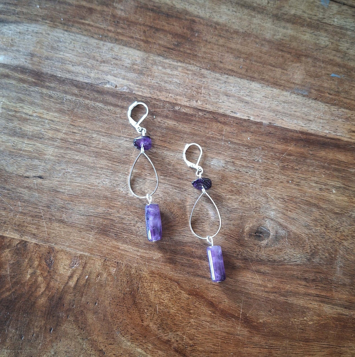 Iris Amethyst Drop Earrings with Sterling Silver Lever-Backs on Wooden Surface.