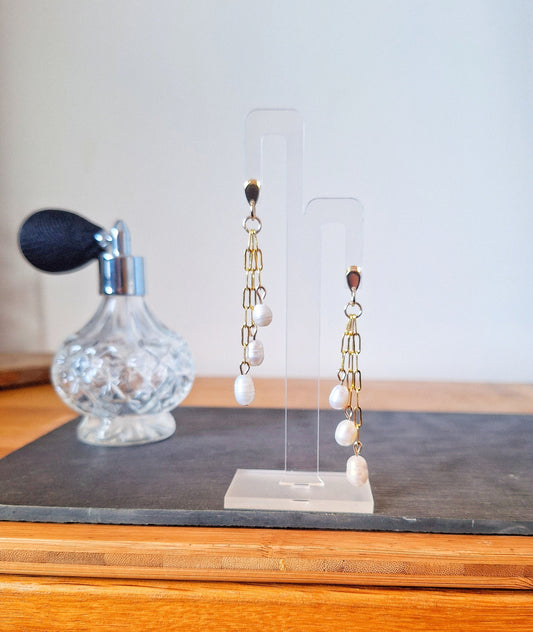 Marilyn Pearl Earrings on display stand, featuring gold-plated chain with repurposed freshwater pearls, showcasing sustainable glamour.