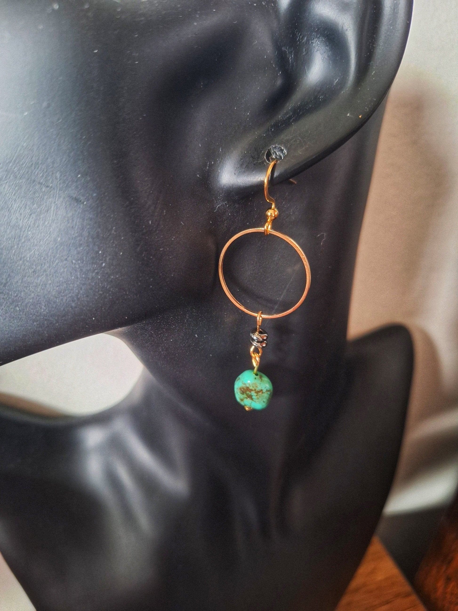 Sofia Turquoise Drop Earrings with turquoise nuggets, gold accents, and black mirrored discs.