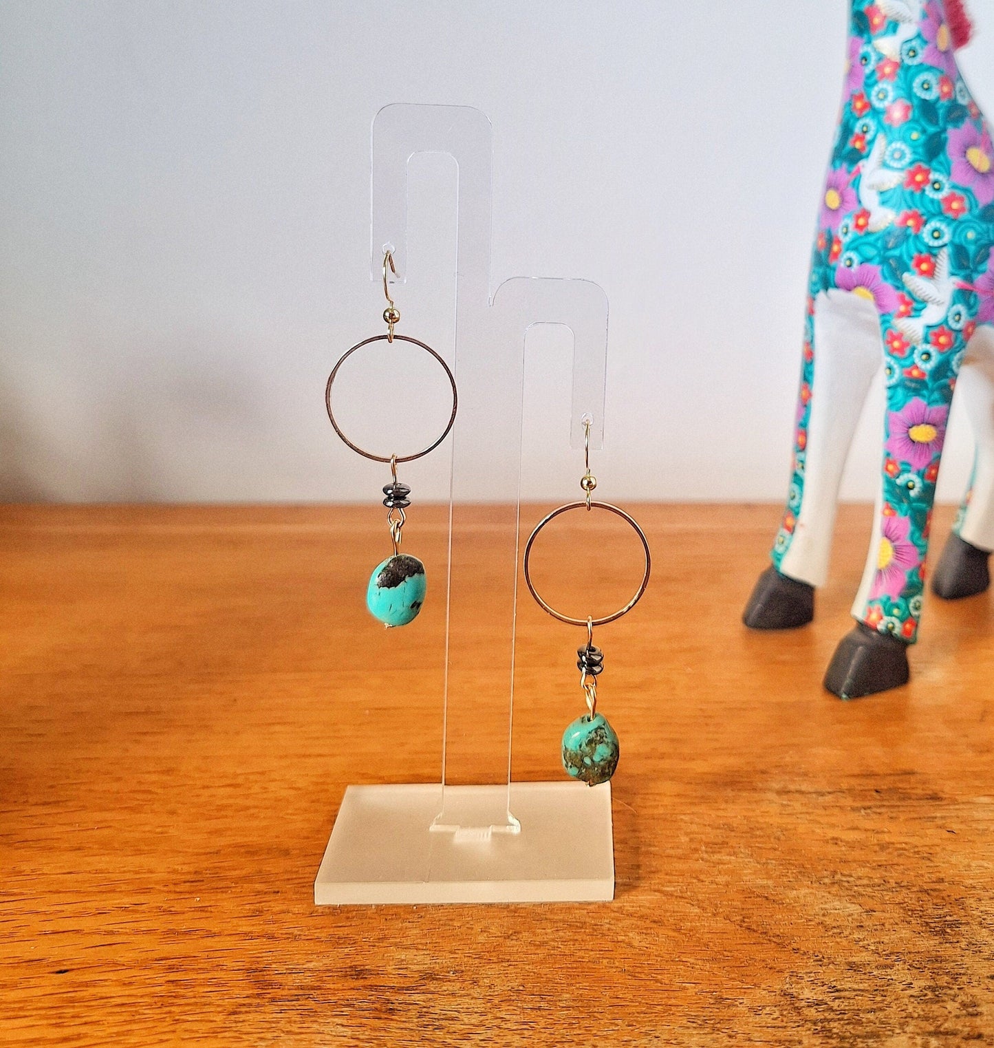Sofia Turquoise Drop Earrings with gold-plated accents and sleek black mirrored discs on display.
