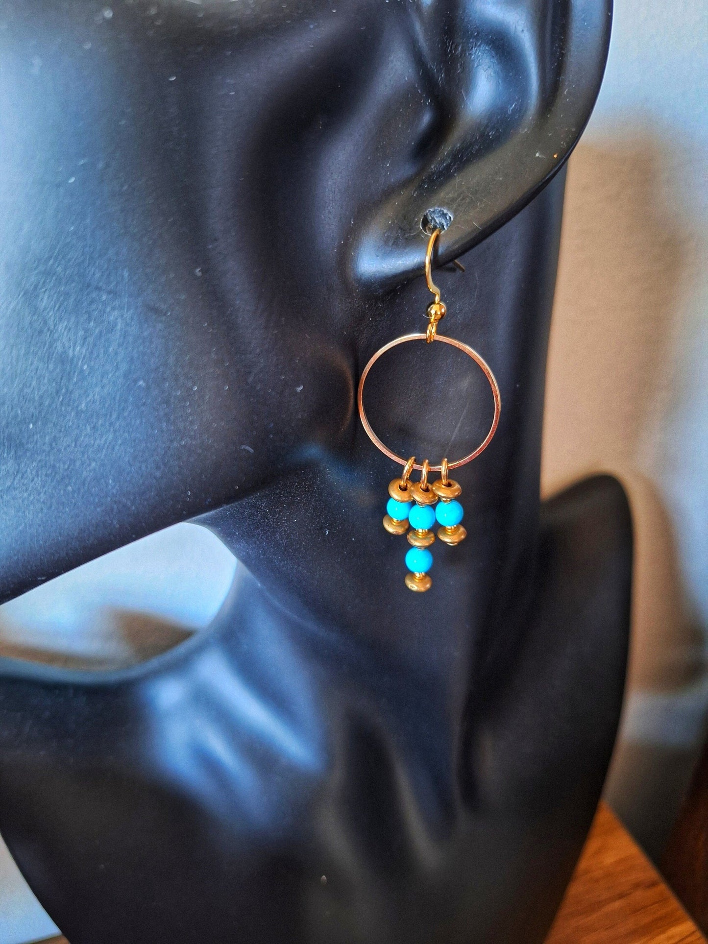 Turquoise chandelier earrings with bronze details and gold-plated accents.