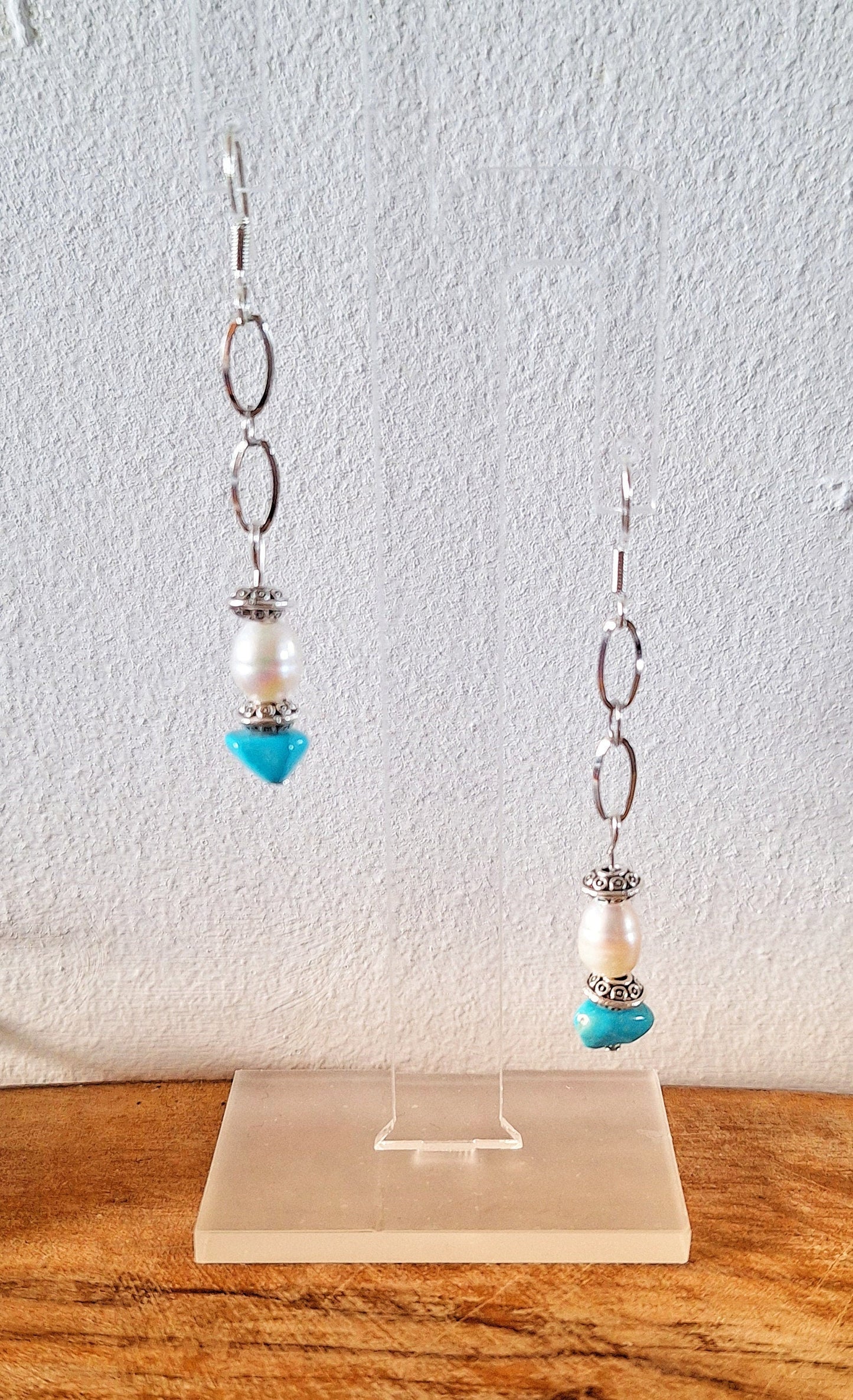 Arabella Turquoise and Pearl Earrings with sterling silver ear wires on display.