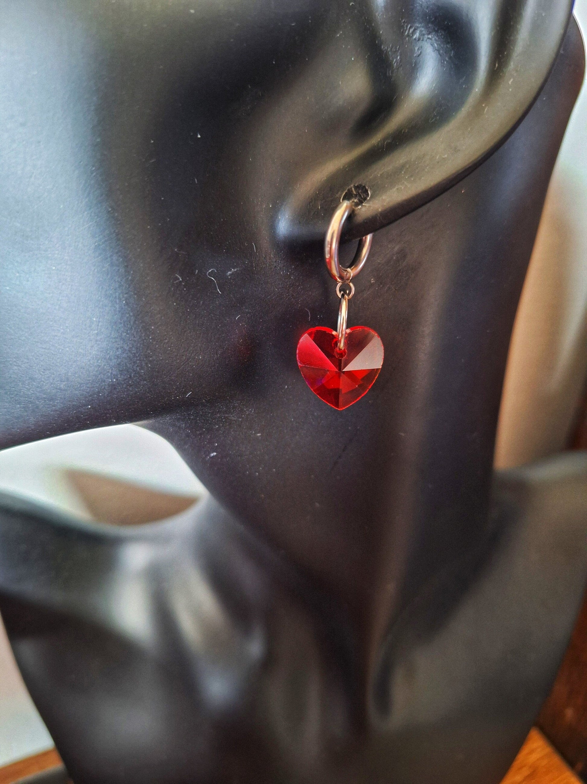 Venus Crystal Heart Huggies with red faceted glass heart bead on stainless steel hoop earring.