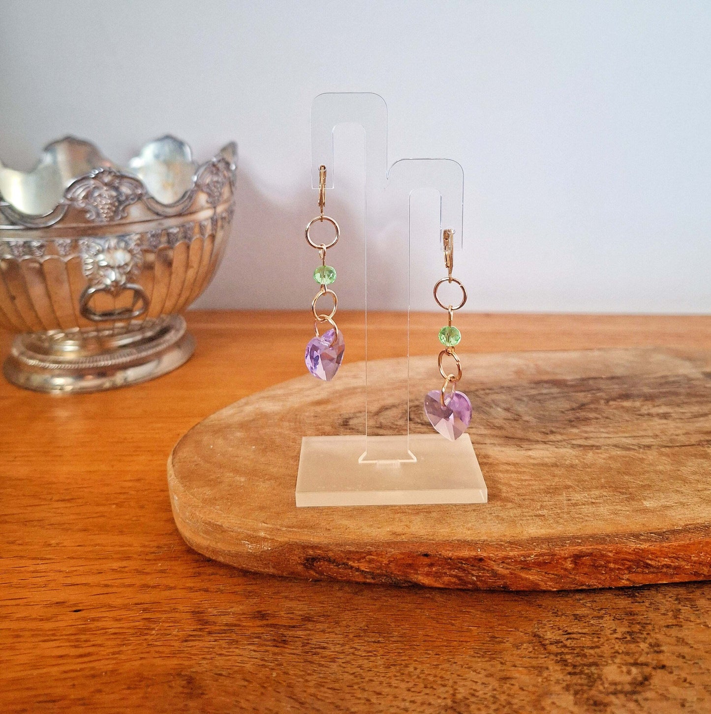 Evelyn Purple Heart Earrings with faceted glass beads and gold-plated hoops on wooden display.