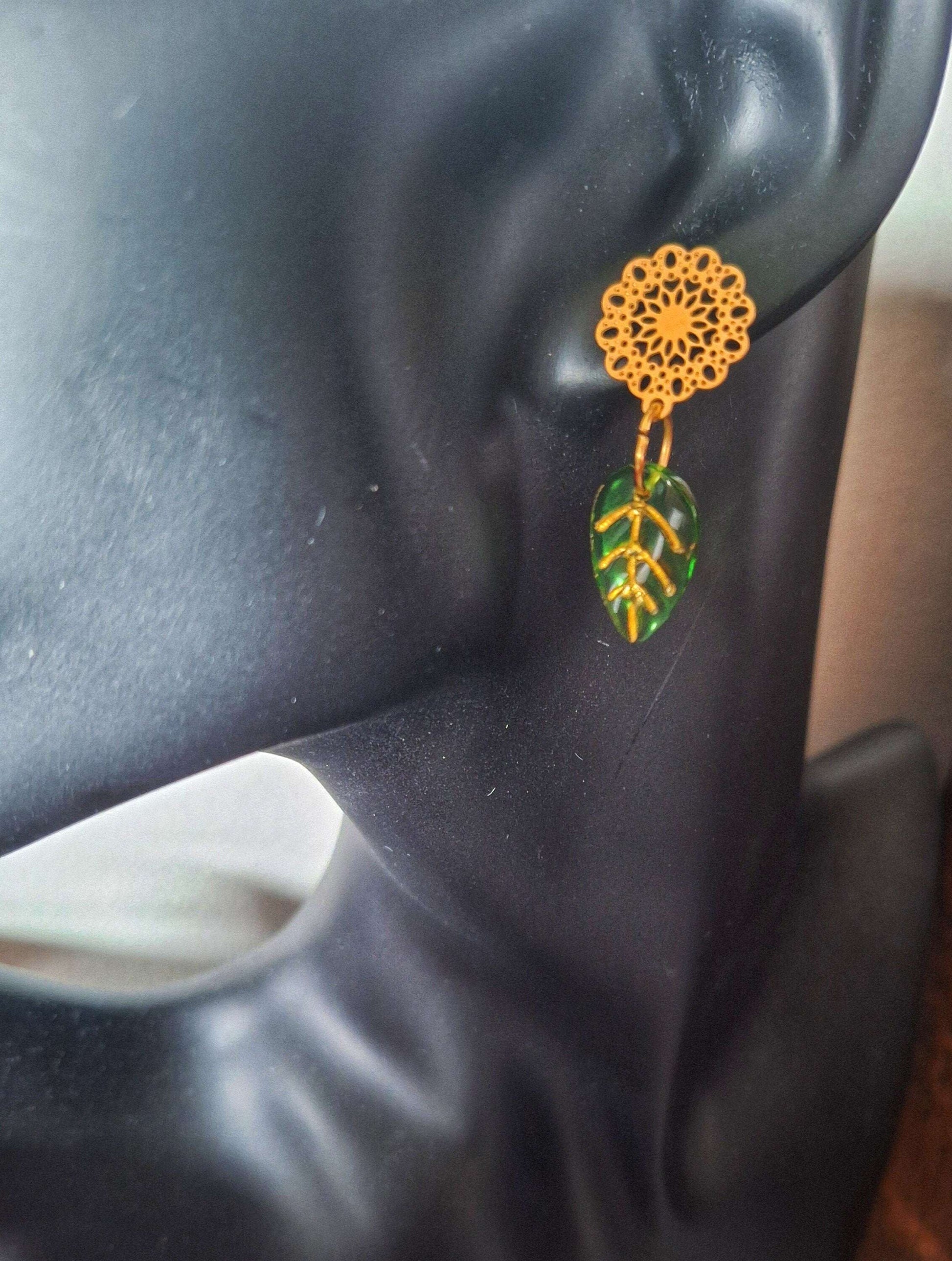 Gold Leaf Earrings with green and gold glass leaves on gold-plated studs.