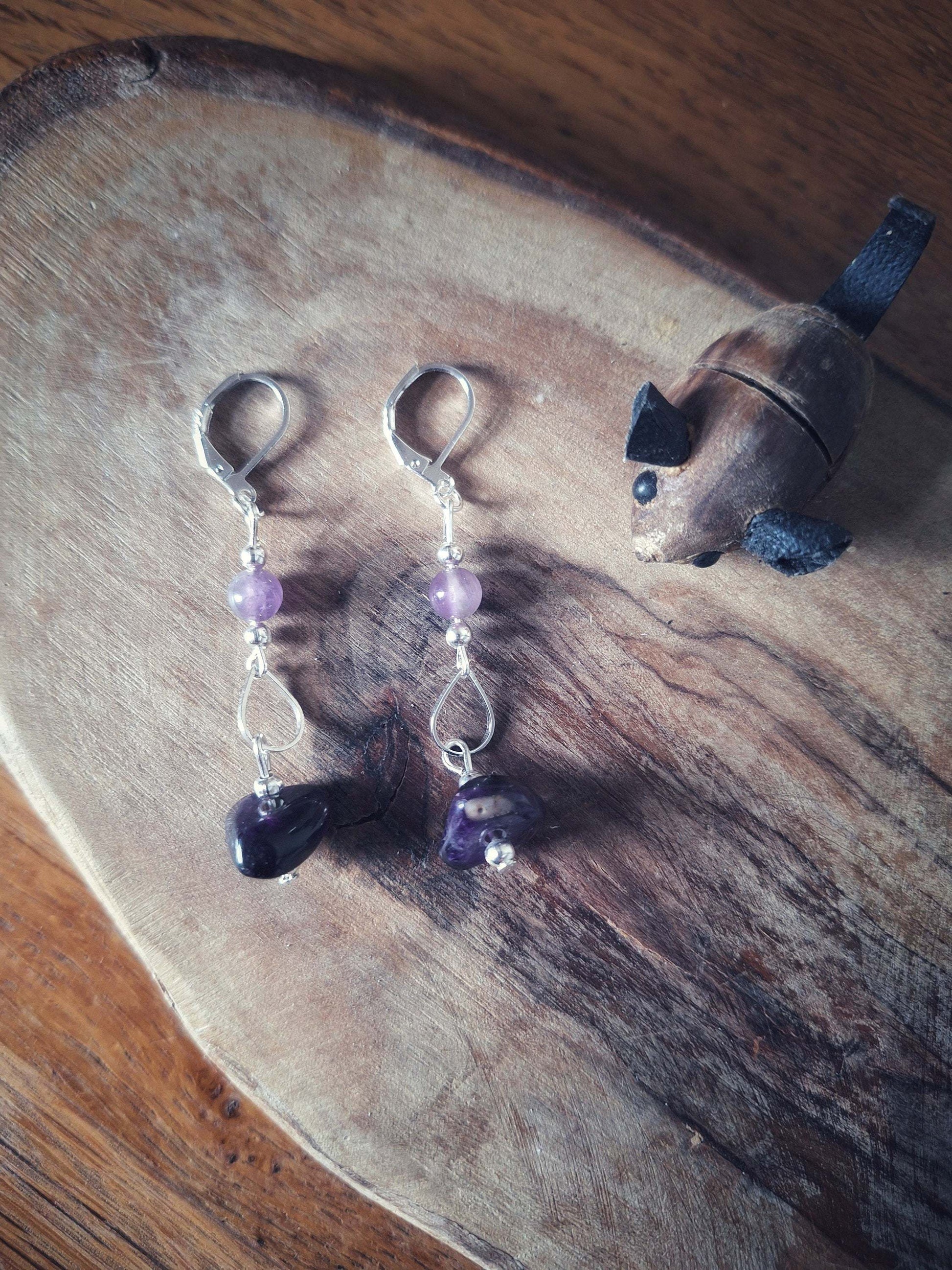 Francine Amethyst Earrings with silver-plated accents on wooden surface.