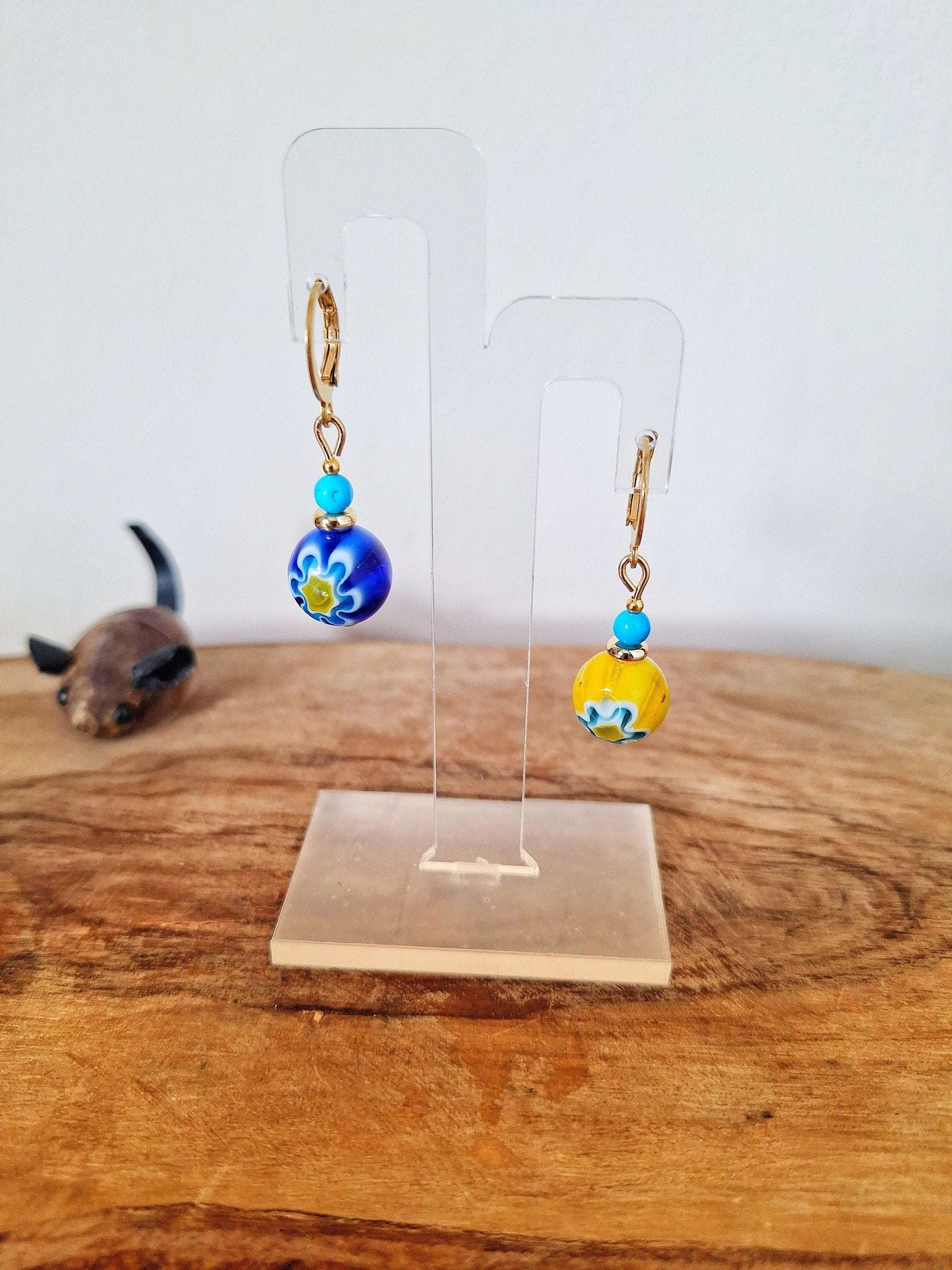 Millefiori Glass Bead Huggies with gold-plated accents on display stand.