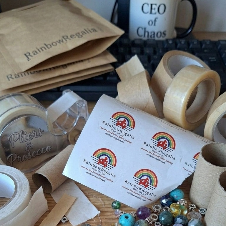 Chaotic desk covered in beads and different types of eco-friendly packaging