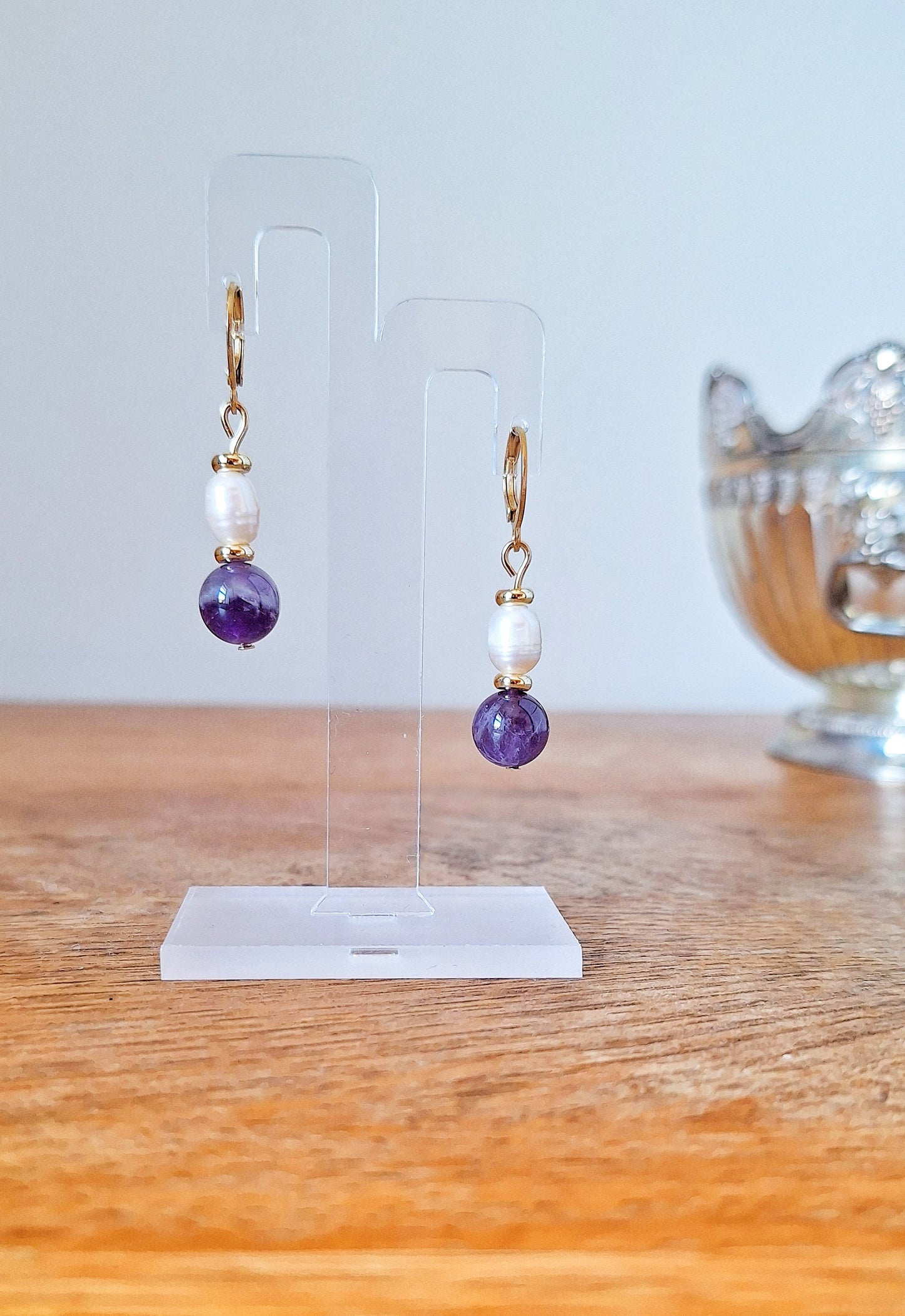 Freshwater pearl and amethyst beads suspended from gold-plated huggies.