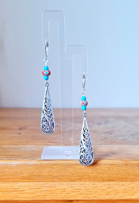 Long, elegant, 80mm drop silver earrings. Made with repurposed turquoise stone and glass beads with silver toned teardrop. Sterling silver lever back ear wires.