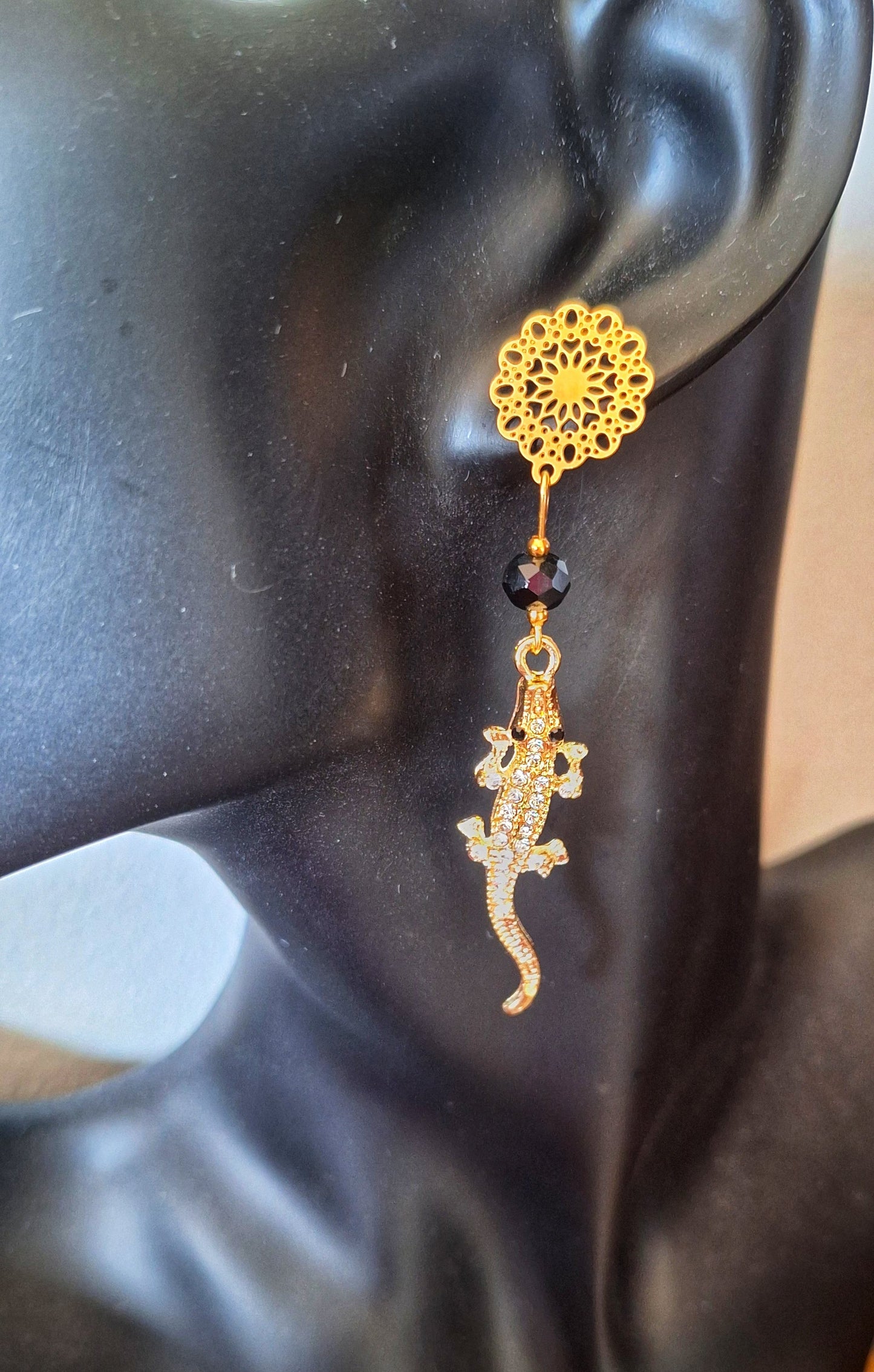 Gold coloured crystal encrusted crocodile earrings with black faceted glass beads