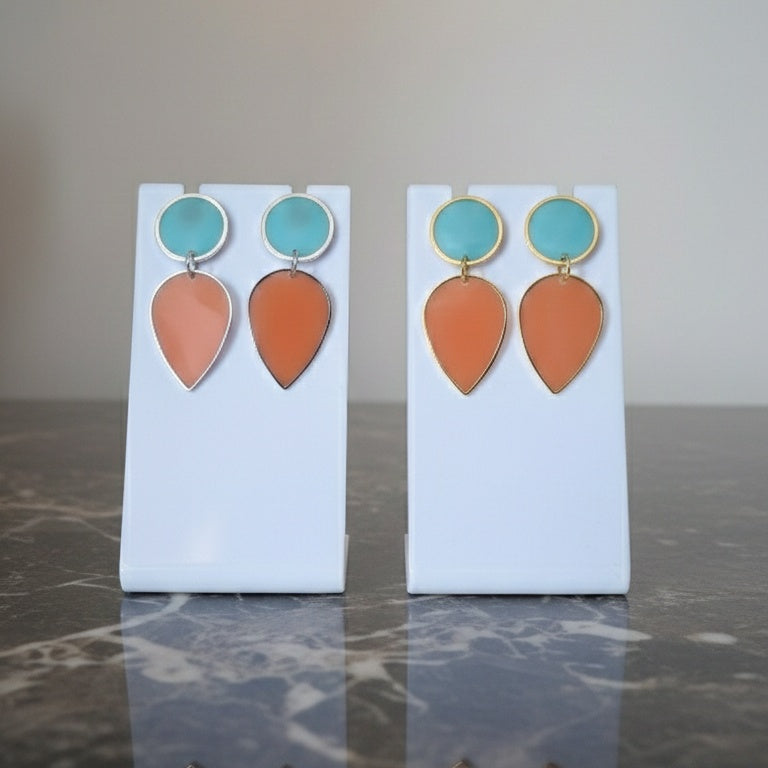 Pair of earrings with turquoise and orange teardrop shapes. Gold or silver finish.