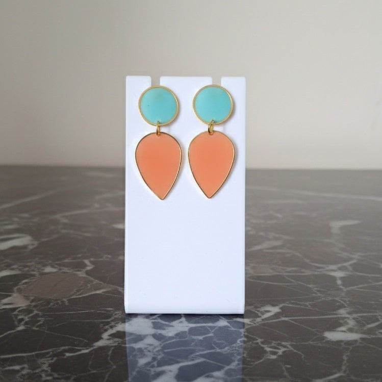 Pair of earrings with turquoise and orange teardrop shapes. Gold or silver finish.