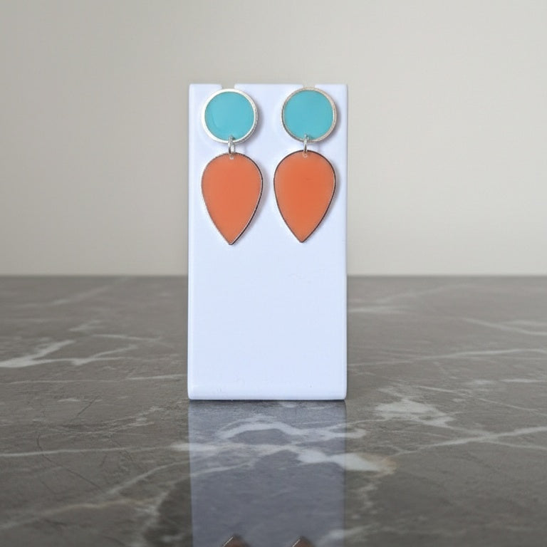 Pair of earrings with turquoise and orange teardrop shapes. Gold or silver finish.