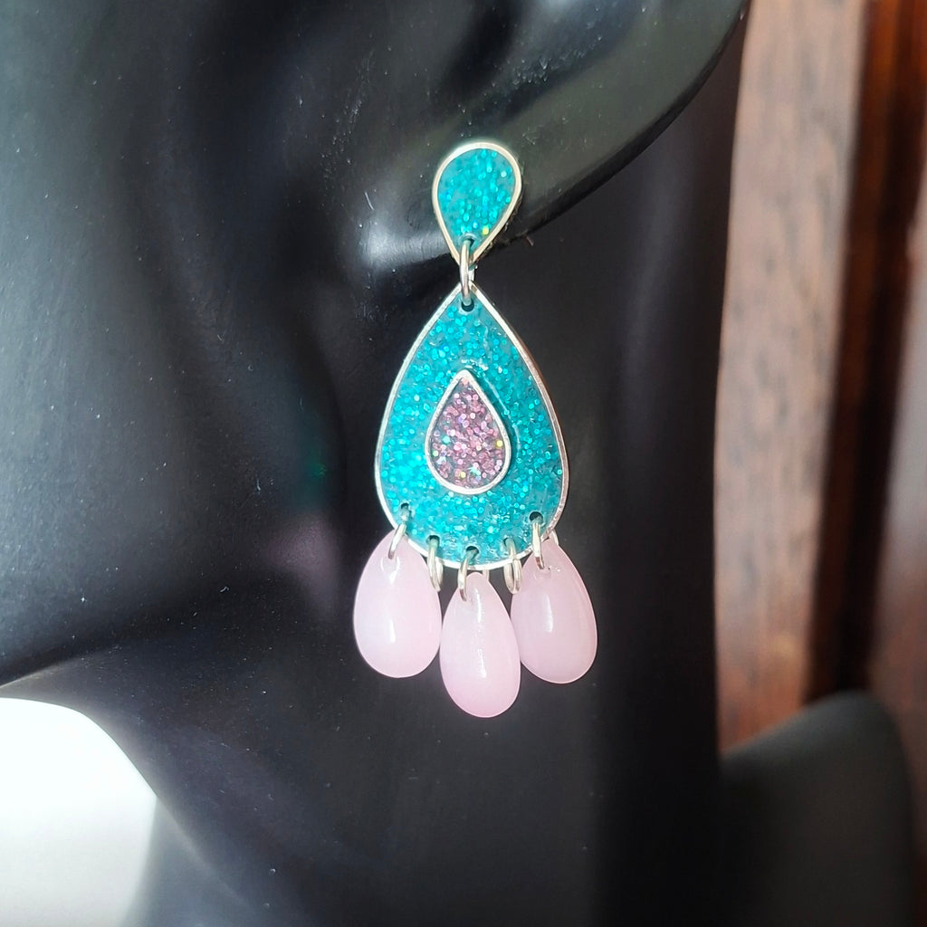Teal and pink teardrop chandelier earrings.