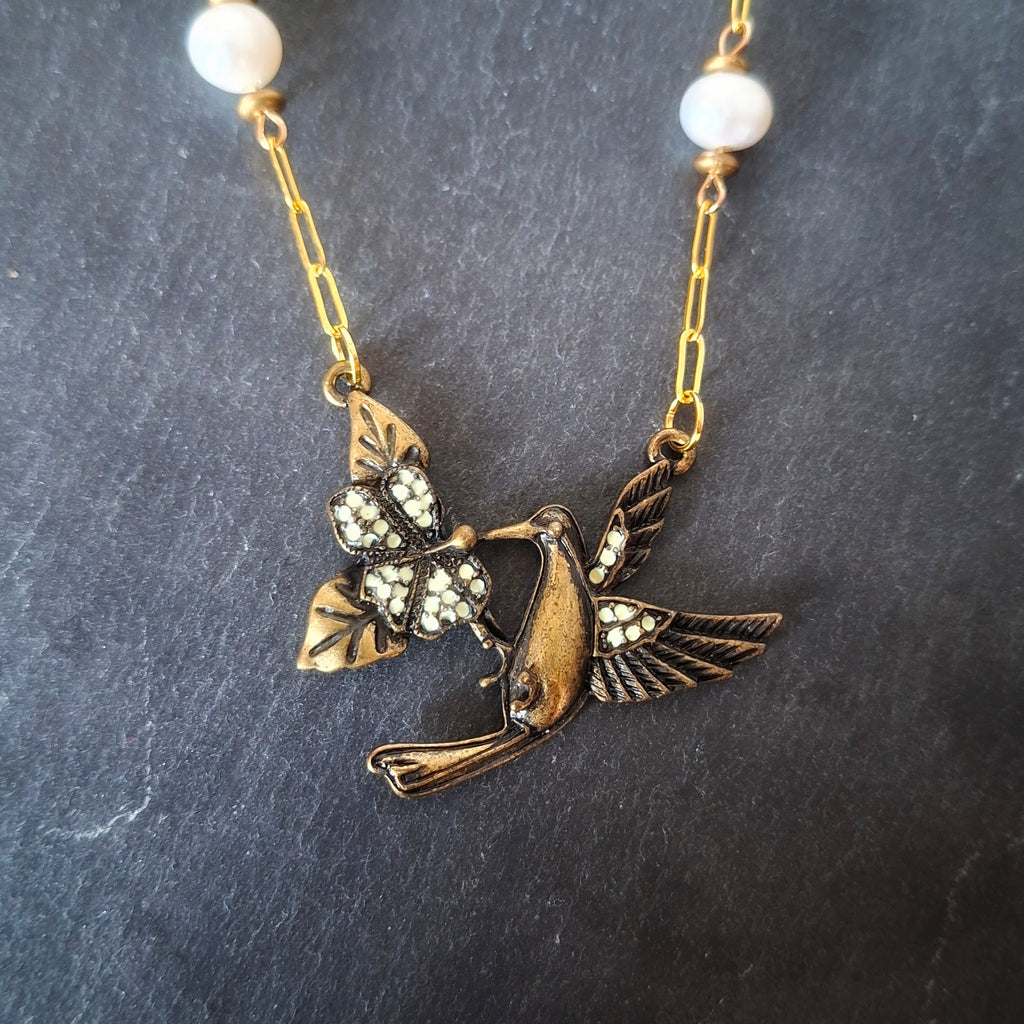 Hummingbird necklace with pearls on a gold chain
