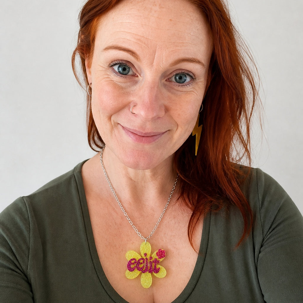 Lime green flower pendant with word 'eejit'.
