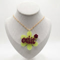 Lime green flower pendant with word 'eejit'.