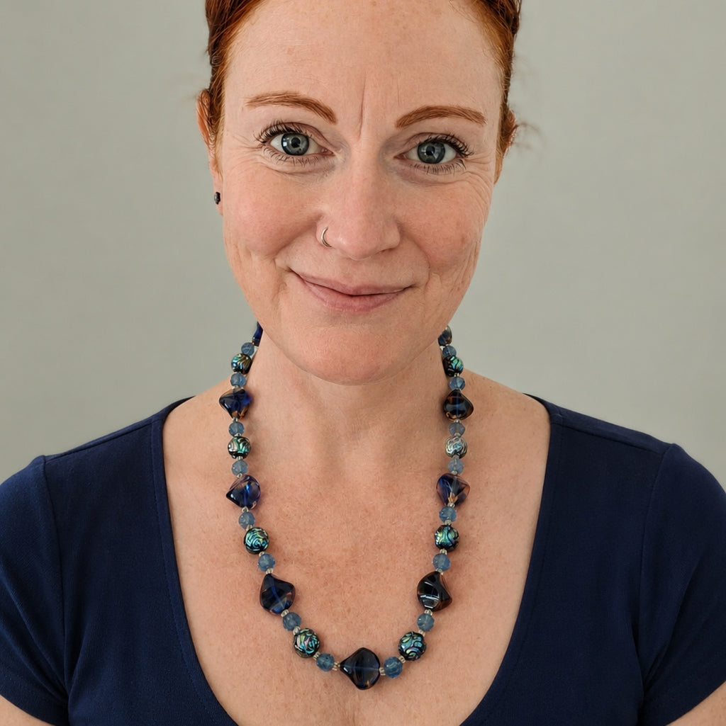 Vintage 1960s French glass necklace. A gorgeous bohemian statement piece featuring rich blue and iridescent caramel beads.