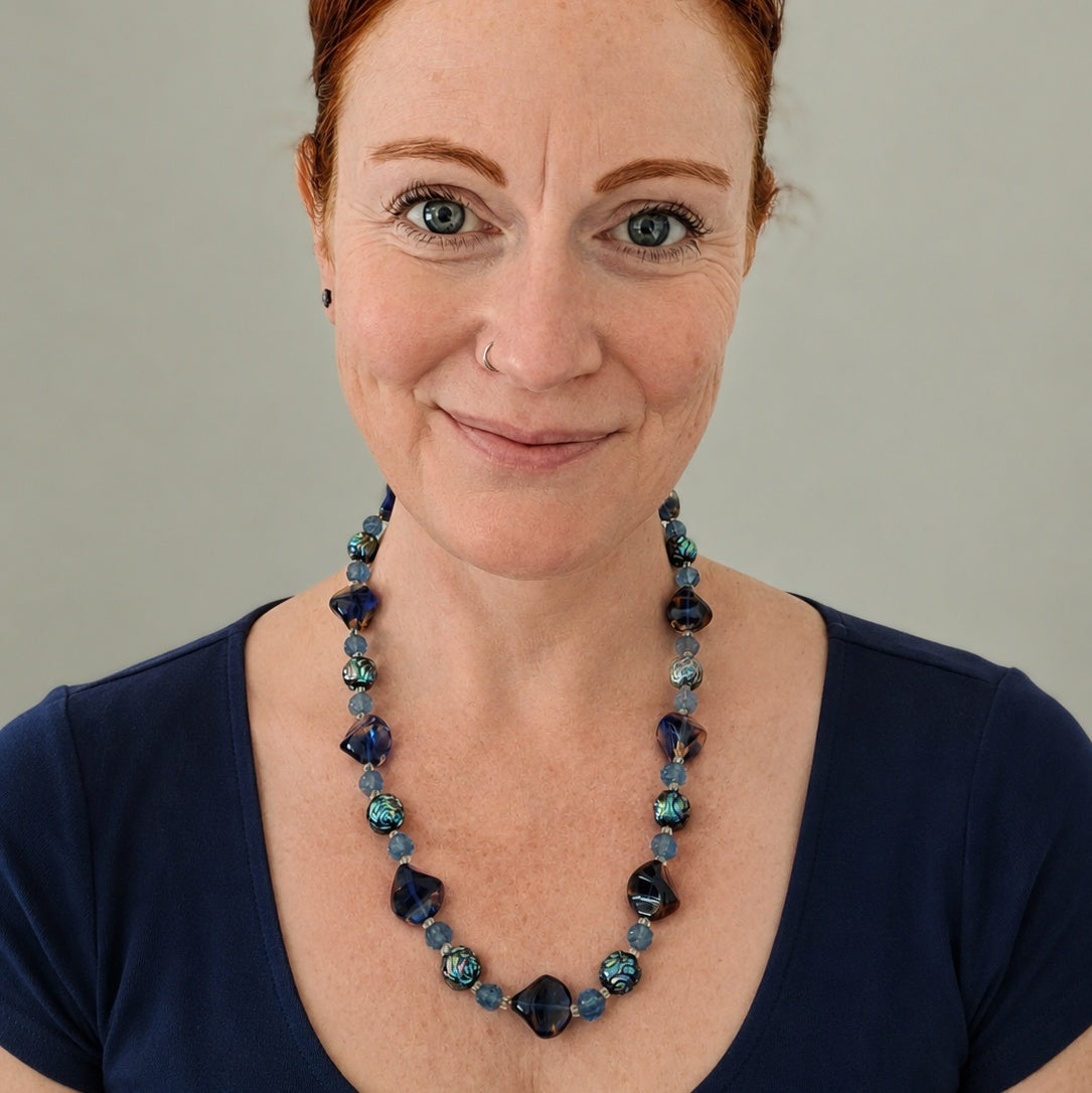 Vintage 1960s French glass necklace. A gorgeous bohemian statement piece featuring rich blue and iridescent caramel beads.