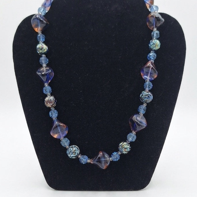 Vintage 1960s French glass necklace. A gorgeous bohemian statement piece featuring rich blue and iridescent caramel beads.