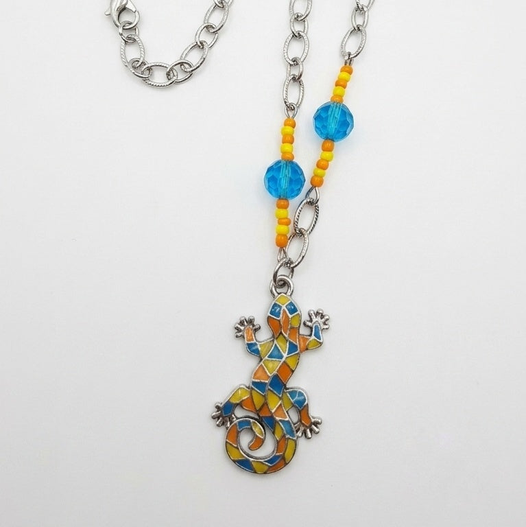 A vibrant bohemian statement piece made from repurposed beads and a mosaic lizard pendant.