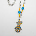 A vibrant bohemian statement piece made from repurposed beads and a mosaic lizard pendant.