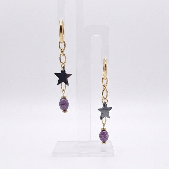 Cosmic Renegade Earrings feature repurposed purple glass beads and matt black stars on stainless steel huggies.