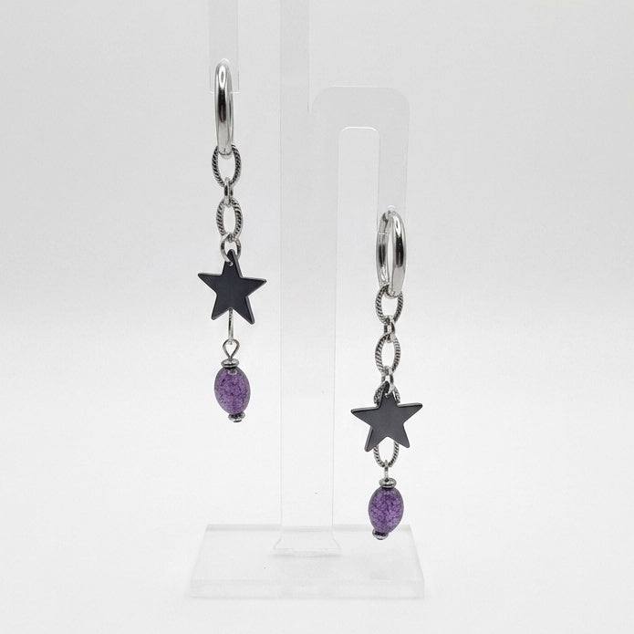 Cosmic Renegade Earrings feature repurposed purple glass beads and matt black stars on stainless steel huggies.