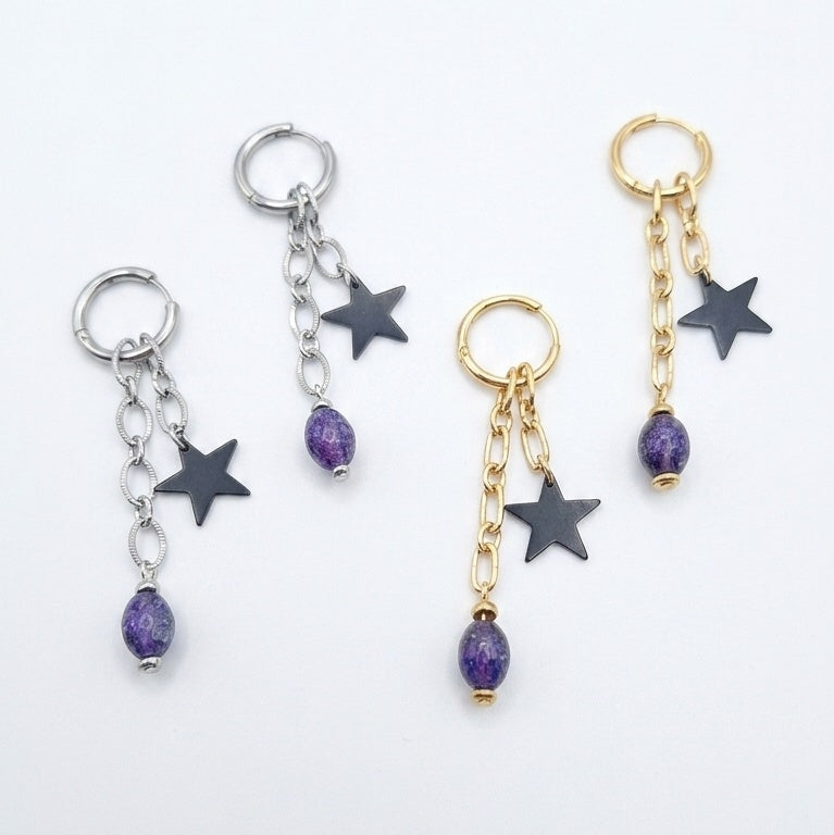 Cosmic Renegade Earrings feature repurposed purple glass beads and matt black stars on stainless steel huggies.