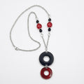 Carnaby Circle vintage necklace with a crimson red and black enamel pendant, vintage glass beads, and a stainless steel chain