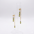 Gold-plated earrings with green glass beads and hematite.
