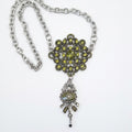 A gothic statement piece upcycled from a vintage rhinestone brooch and H. Dubin elements.