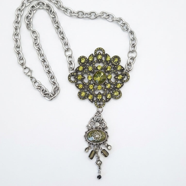A gothic statement piece upcycled from a vintage rhinestone brooch and H. Dubin elements.