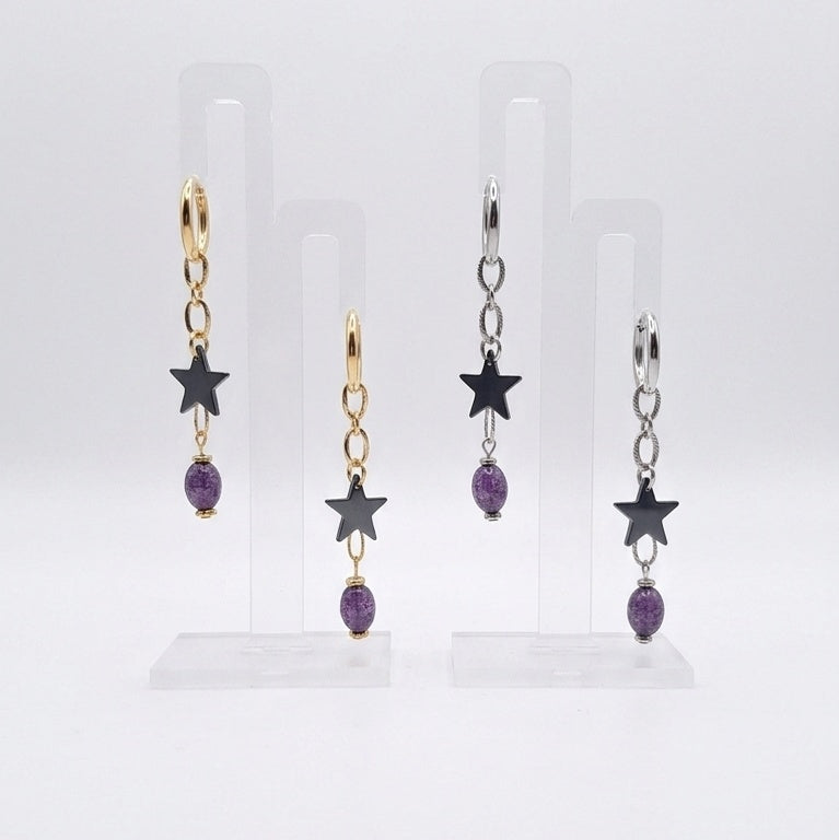 Cosmic Renegade Earrings feature repurposed purple glass beads and matt black stars on stainless steel huggies.