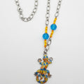 A vibrant bohemian statement piece made from repurposed beads and a mosaic lizard pendant.
