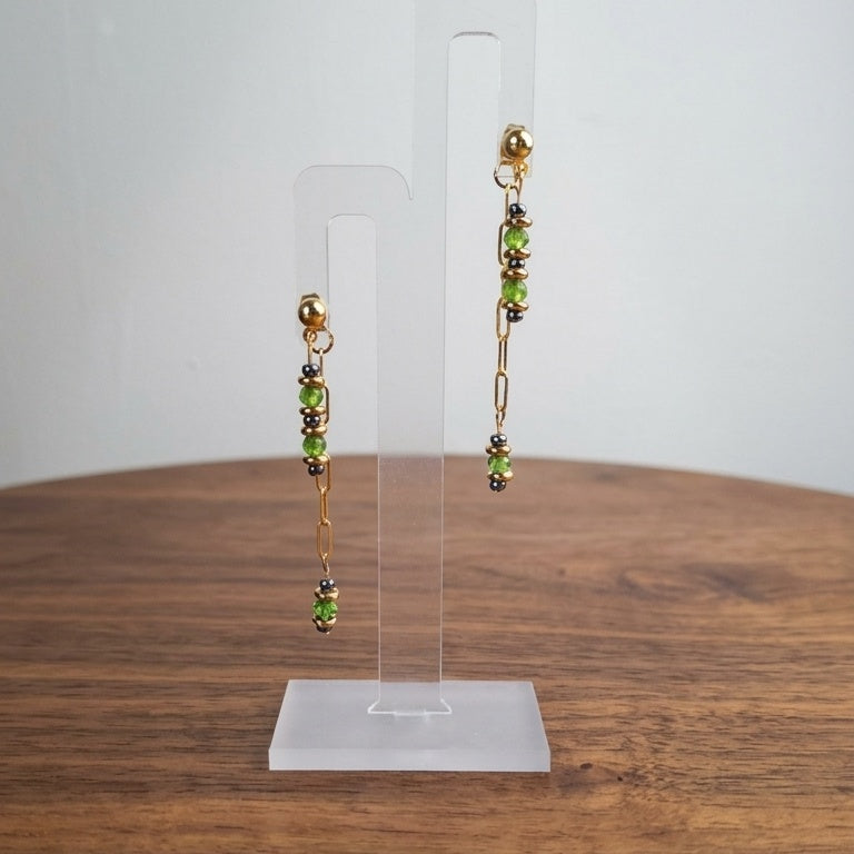 Gold-plated earrings with green glass beads and hematite.
