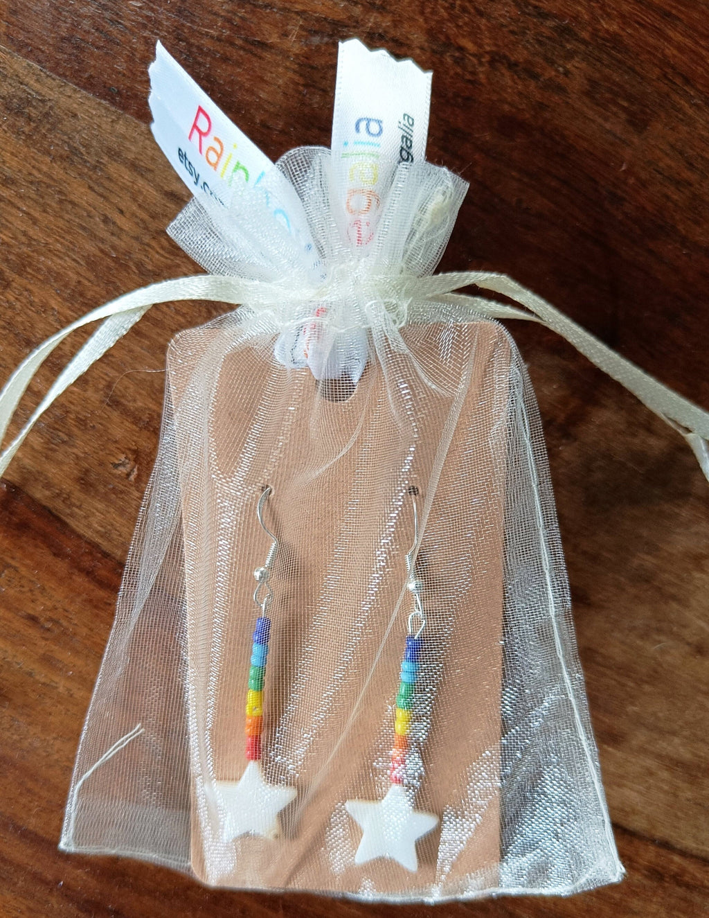 Rainbow Star Earrings with rainbow glass beads and star-shaped shell in gift pouch.