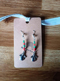 Red and green angel earrings with dangle design, featuring repurposed glass seed beads.