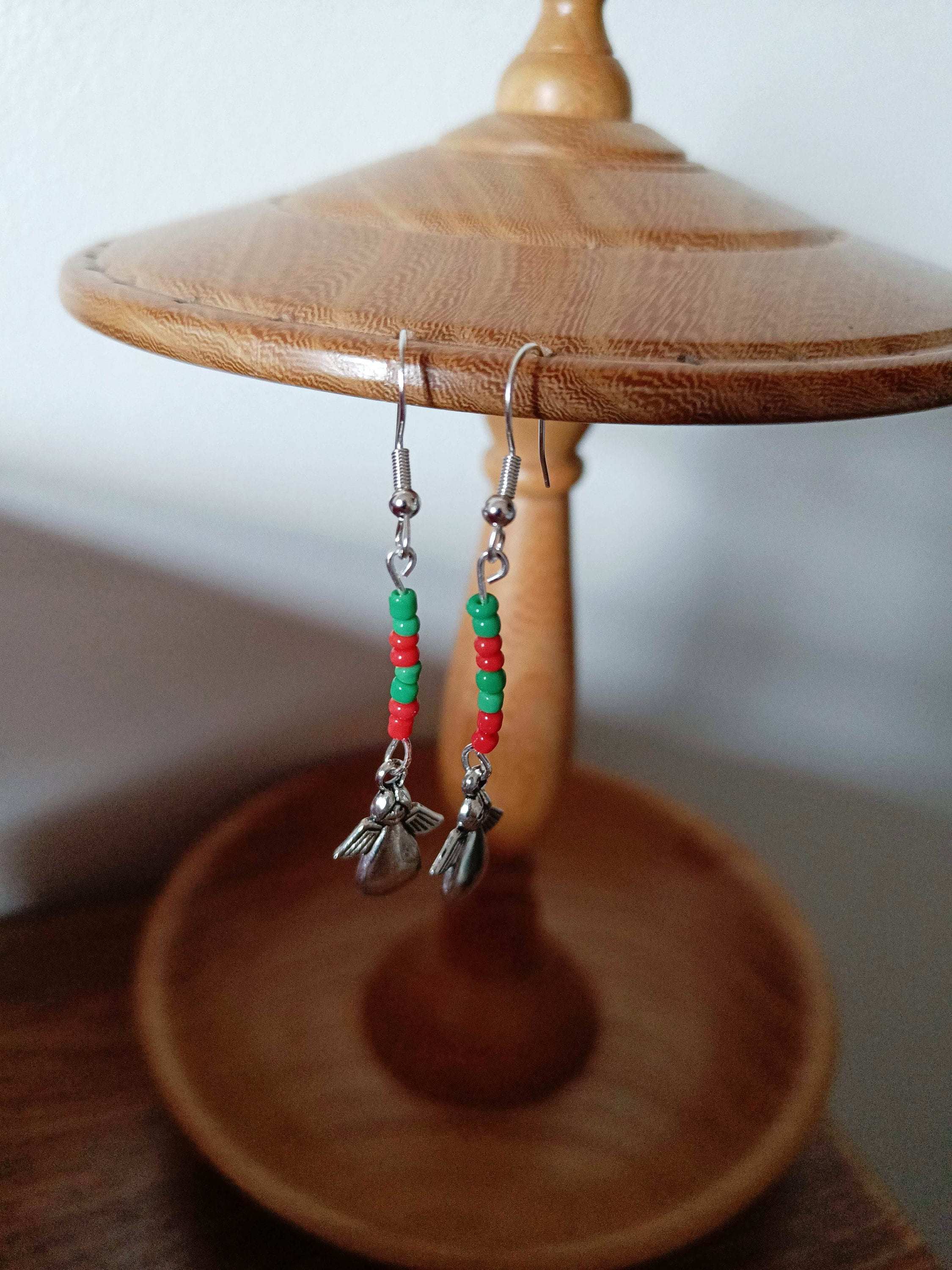Red and green angel earrings with handcrafted dangle design made of repurposed glass seed beads.