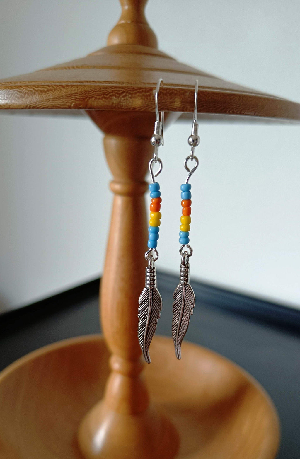 Multicolour feather earrings with antique silver feathers and repurposed glass seed beads.