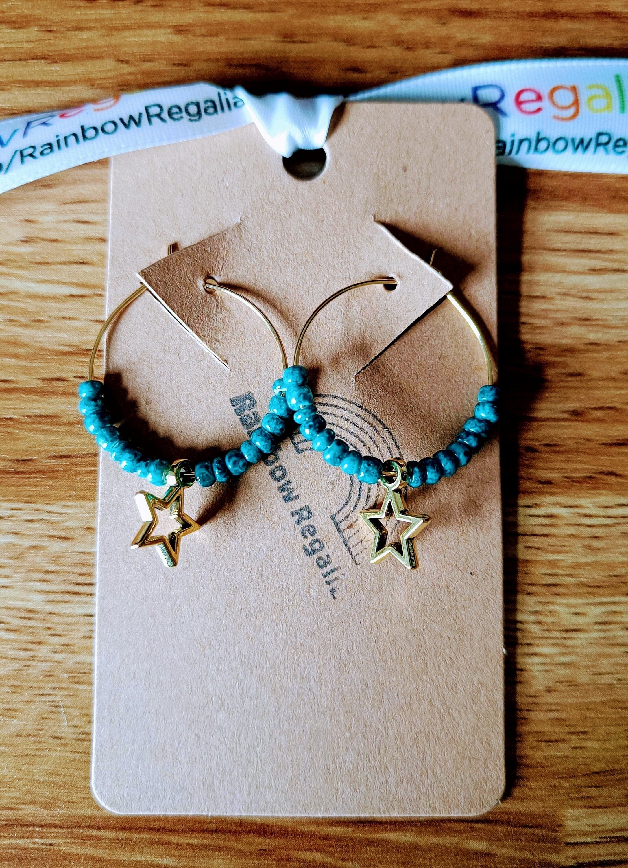 Teal Star Hoops with gold brass, teal ceramic beads, and gold star charm.